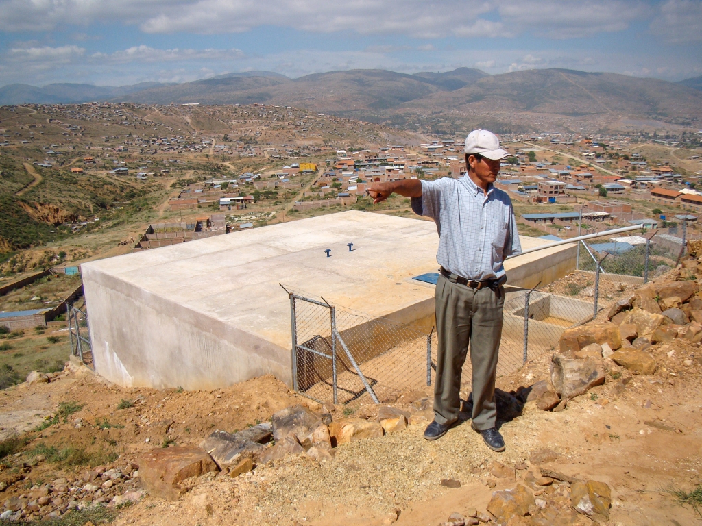 Don Félimón & the water tank his community built.